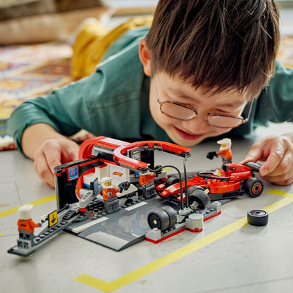 Criança a brincar com o Lego City Boxe de F1 e Equipa da Boxe com Carro da Ferrari