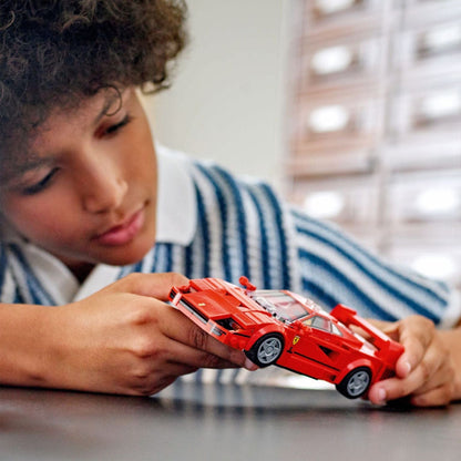 Rapaz a brincar com o Ferrari F40 LEGO Speed Champions numa mesa