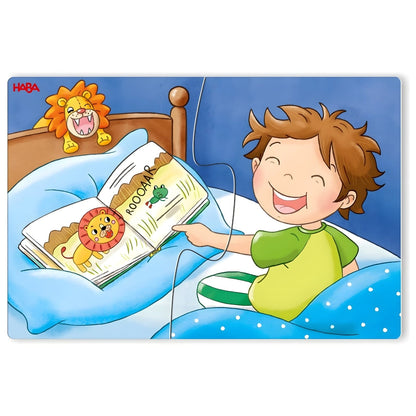 Puzzle HABA com menino a ler um livro na cama