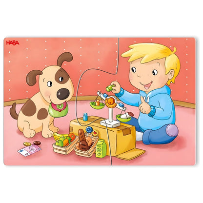 Puzzle HABA com menino e cão a brincar com brinquedos