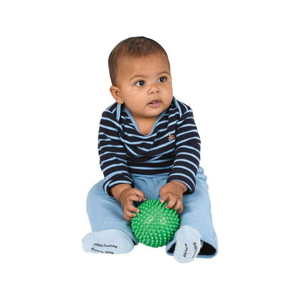 Bebé sentado a segurar a Bola Sensorial Verde