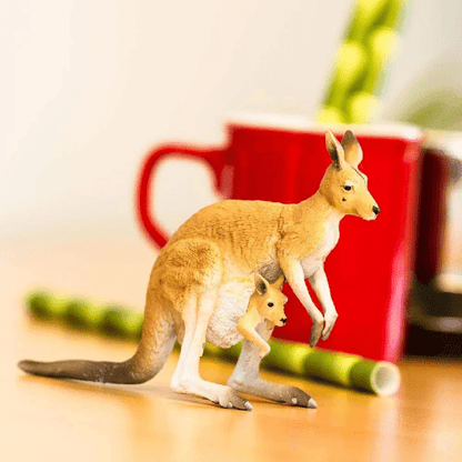 Figura de borracha Canguru Vermelho com cria numa mesa junto a uma caneca