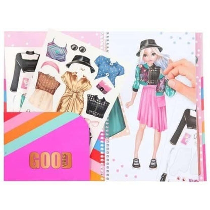 Livro Dress Me Up aberto com modelo e autocolantes de roupa