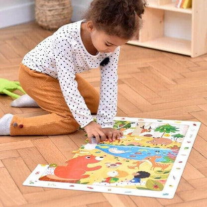 Criança a montar o Puzzle de Observação da Floresta no chão